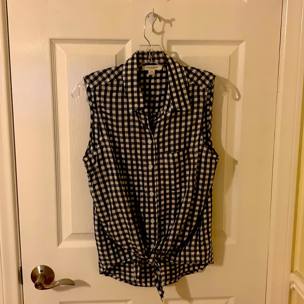 Black and white checkered blouse. Ties just below waist. Made of 100% viscose